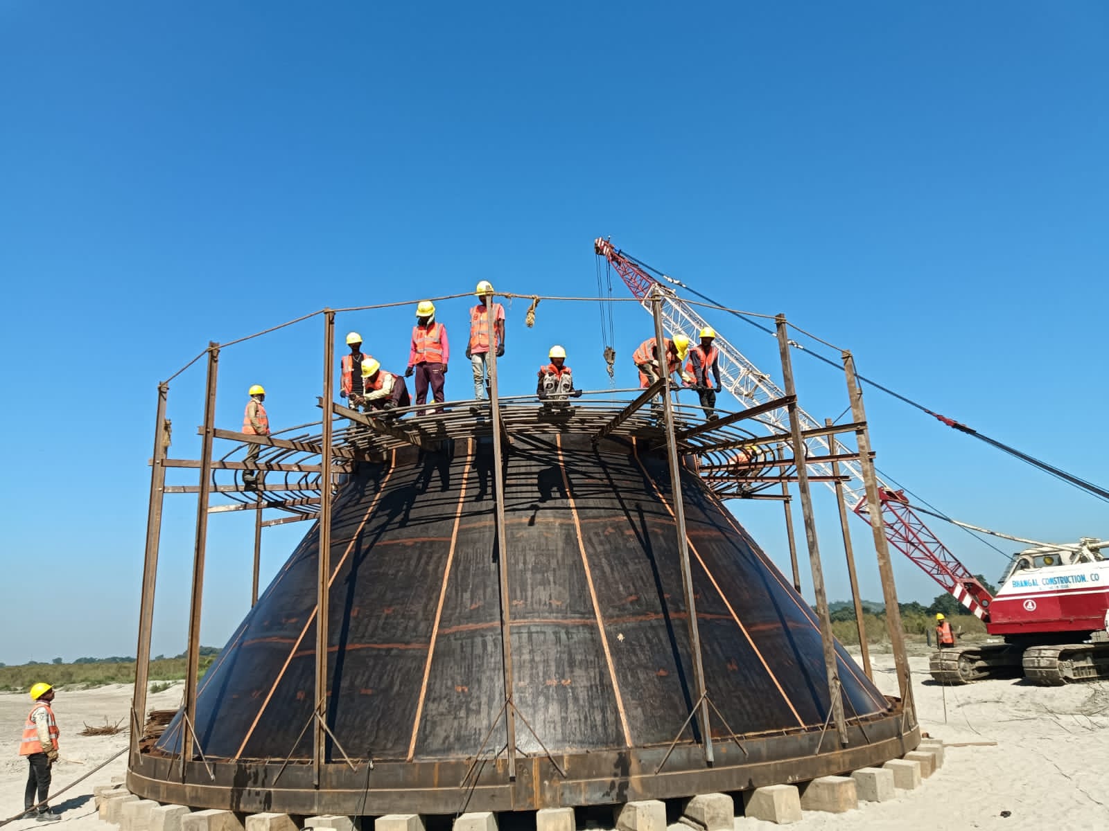 Large dome well construction with team working on curved concrete structure